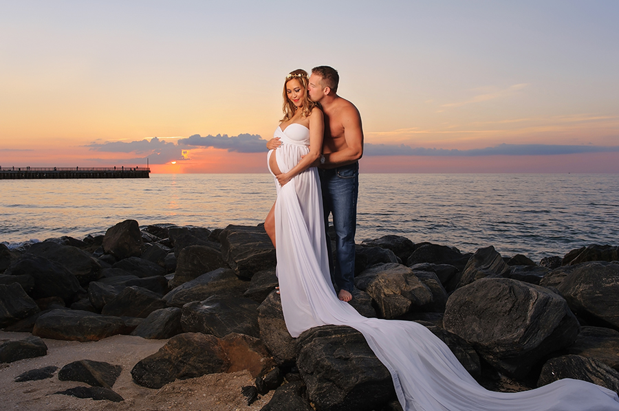 Happy Pregnant Couple on the Rocks