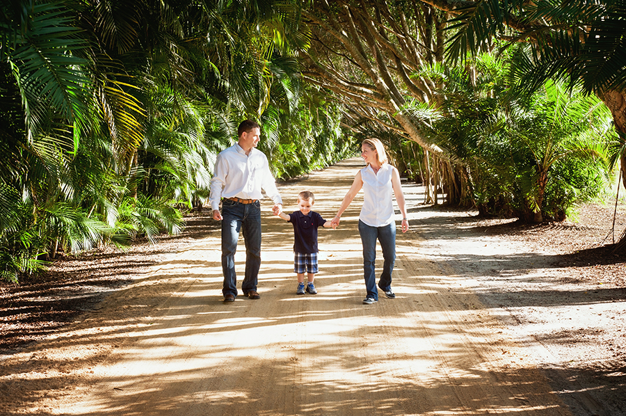Family Walking Along Tree Lined Path